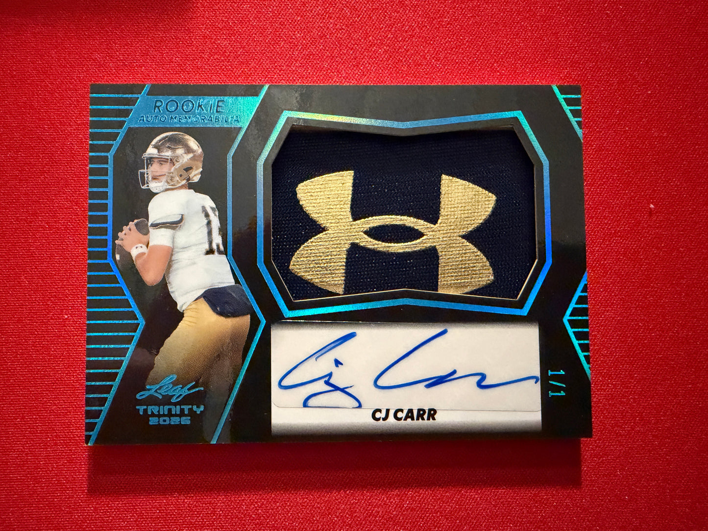 CJ Carr 2026 Leaf Trinity Rookie Auto Mem Black Gold Under Armor Logo Patch 1/1